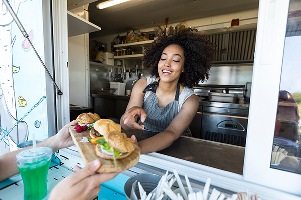 A woman serving food out of a takeout menu