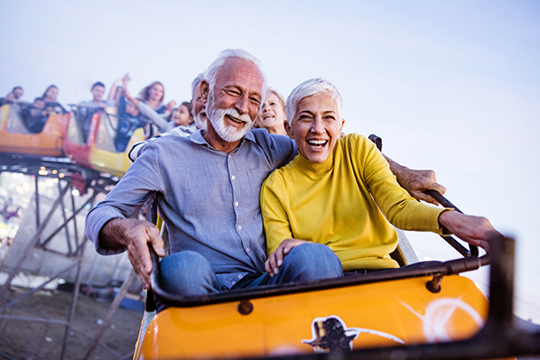 An older couple riding a roller coaster