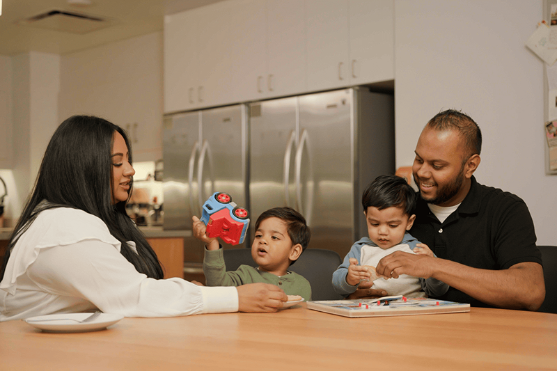 A family of four sitting at their kitchen table