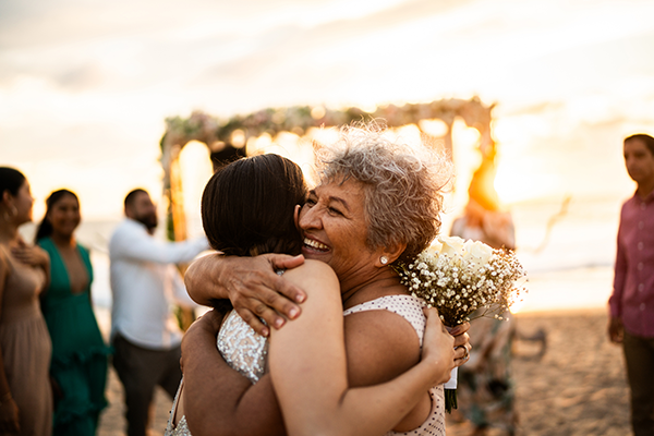 Two women hugging on a beach
