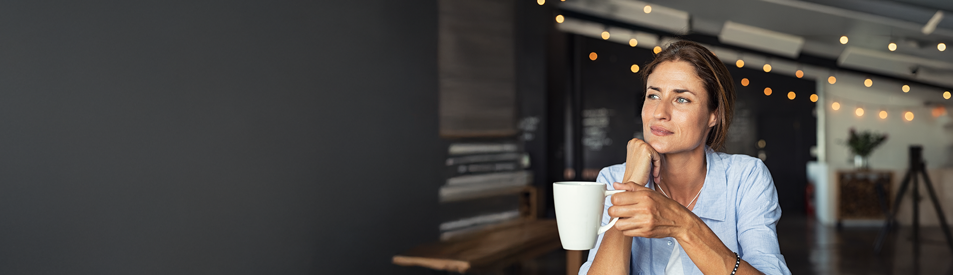 woman in kitchen with cup of espresso